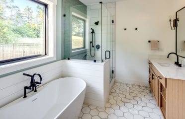 Master bath with tile, modern tub and shower