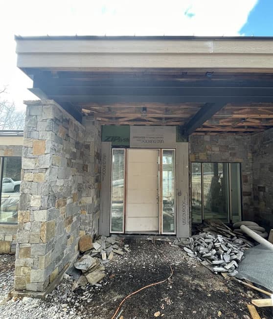 Construction in process: stone entryway with white door